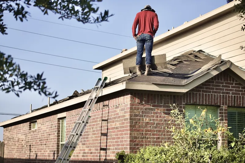Professional roofer working on a residential roof in Washington Square